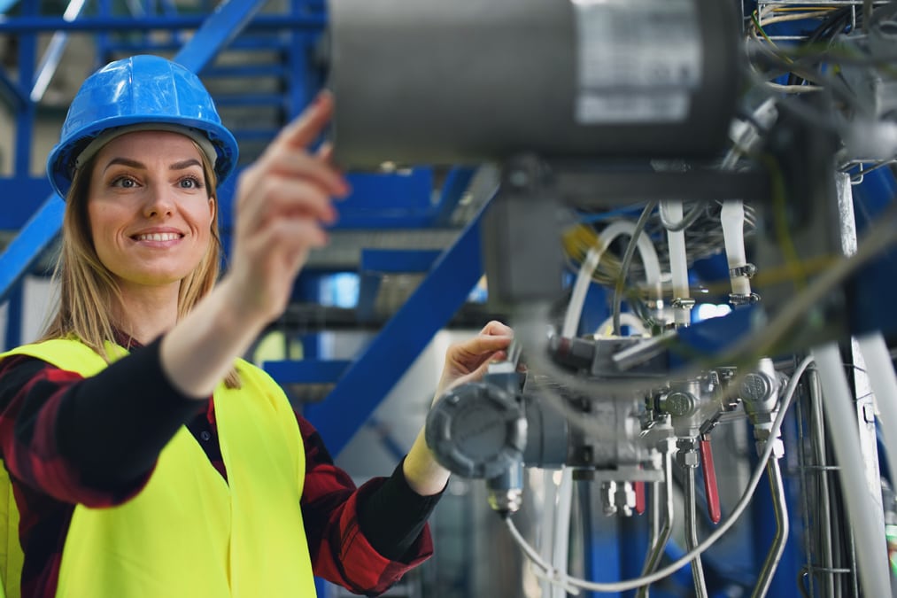 Happy female engineer working in plant